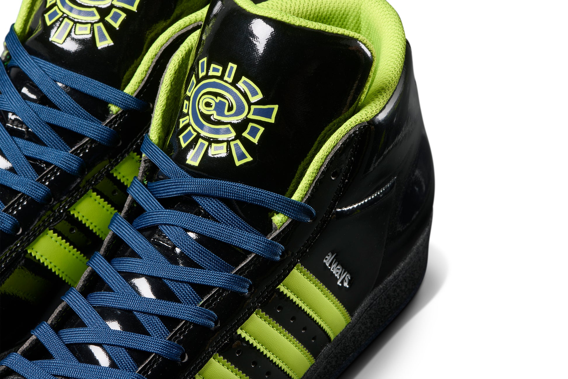 close up view of tongue on black patent leather sneaker with the always do what you should do symbol on the tongue