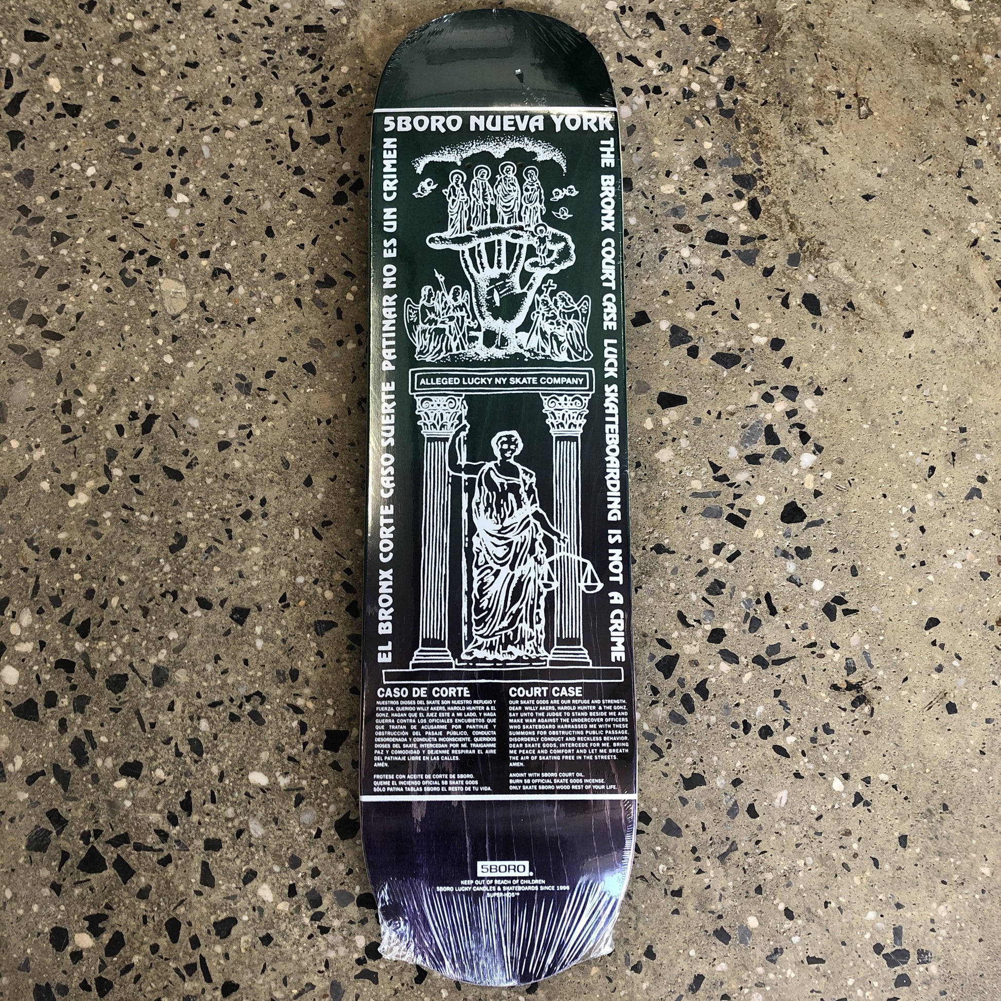 dark blue skateboard with white text and drawings