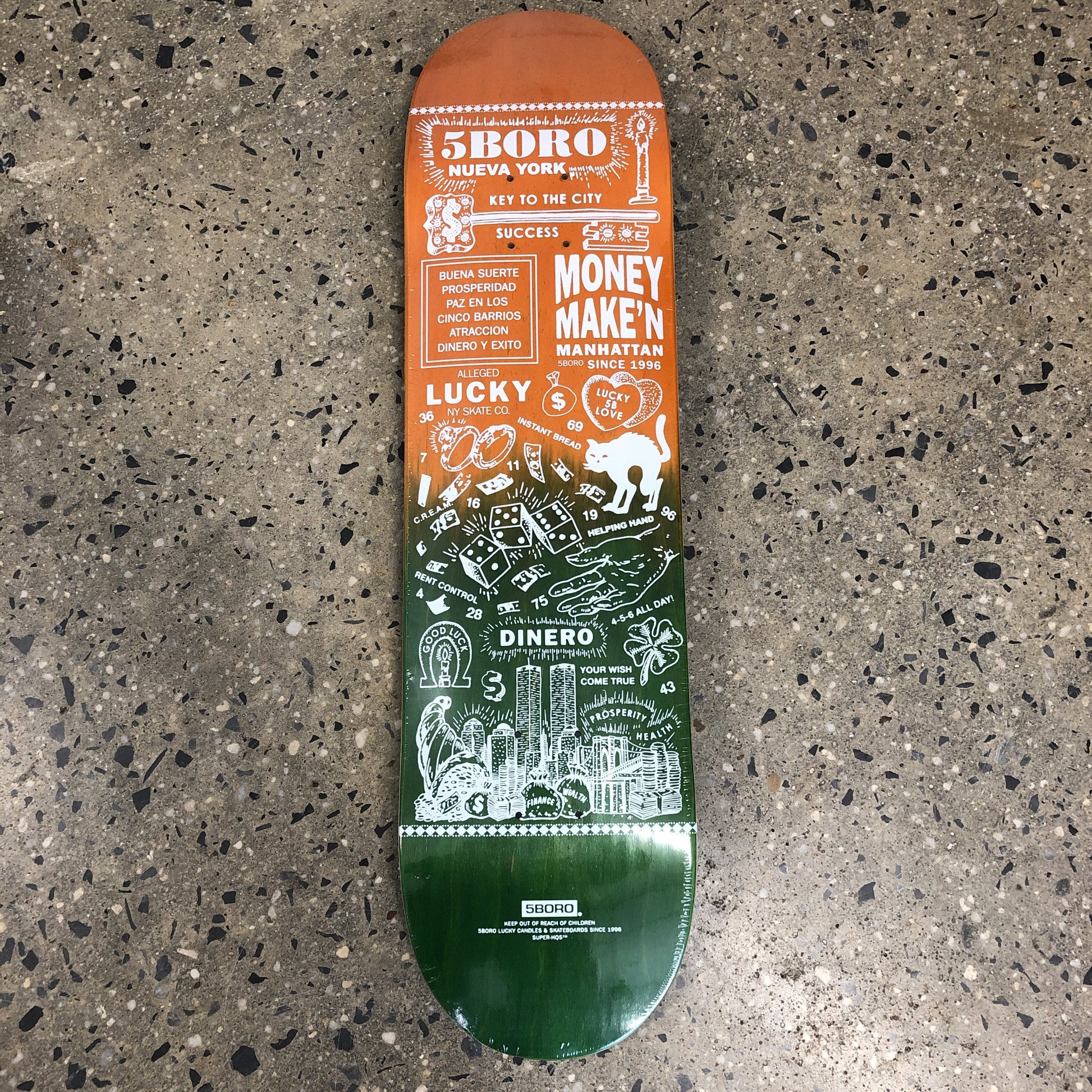 orange and green skateboard with white text and drawings