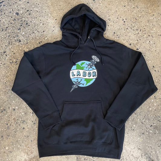 cartoon drawing of earth with a LABOR banner across it, with a screw going through the earth printed in the center chest of a black hoodie