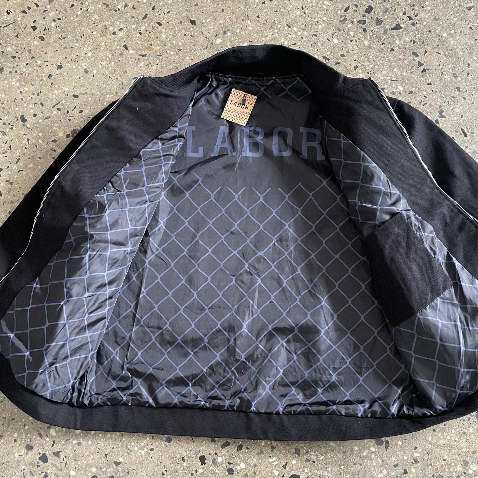 larger view of jacket open, grey fence print on inside of jacket